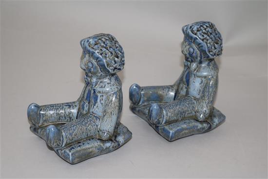 A pair of Clarice Cliff golly blue mottle glazed bookends, height 15.5cm, one damaged